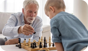 Grandfather teaching his grandson to play chess, staying mentally sharp with Phytomem One